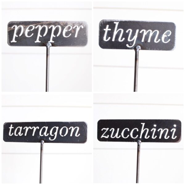 4 different metal garden stakes that read pepper, thyme, tarragon, and zucchini