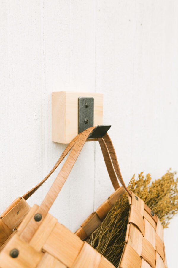 close up of a metal hook block with a bag hanging on it