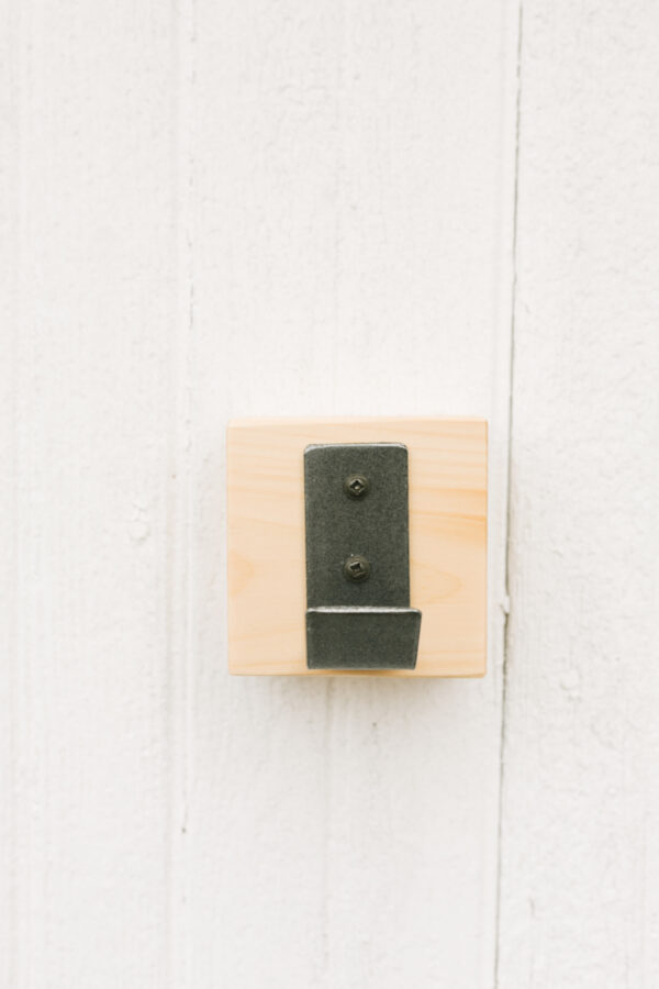 metal hook block hanging on a wall