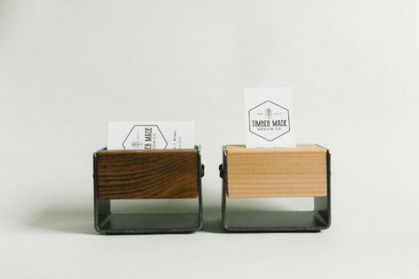 two small wooden business card holders. one is stained in dark walnut and the other has a natural stain