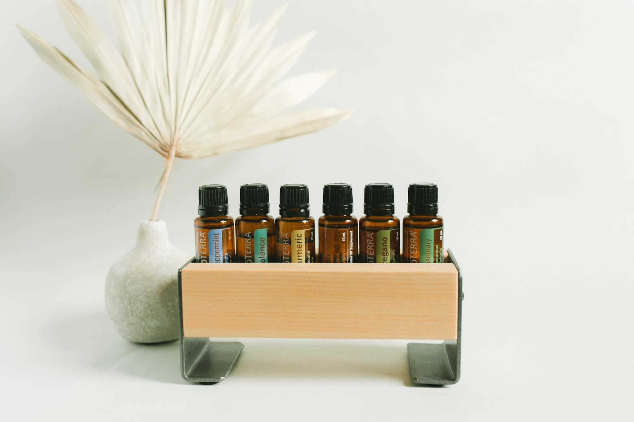 small wood essential oil tray holding 6 essential oil bottles