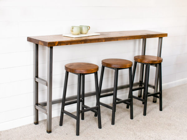 Industrial Wooden Sofa Table against a wall with 3 bar stools