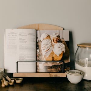 Ambrosia maple cookbook standing holding a cookbook