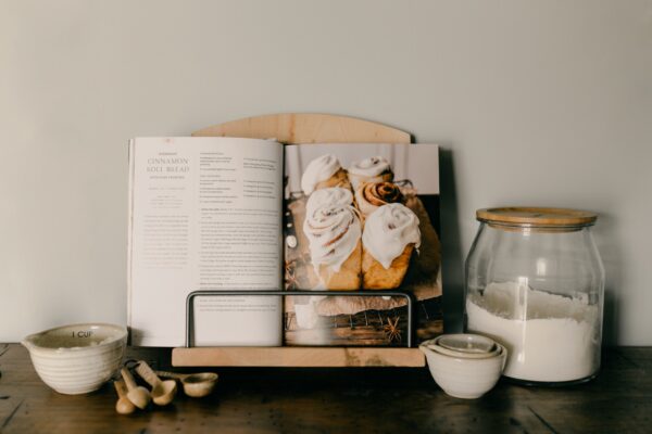 Ambrosia maple cookbook standing holding a cookbook