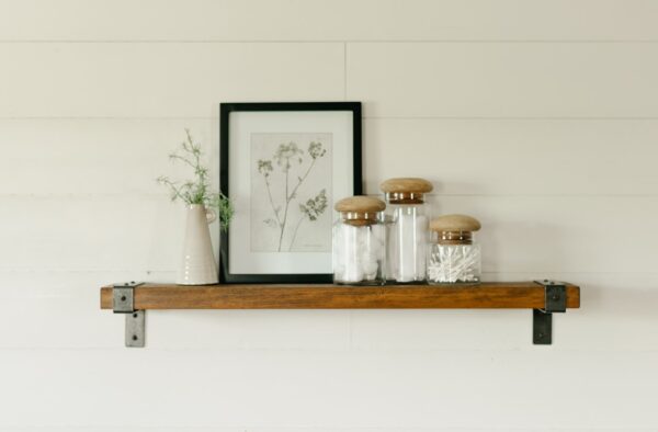 wooden industrial shelf hanging on a wall