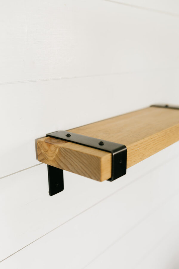 wooden industrial shelf hanging on a wall