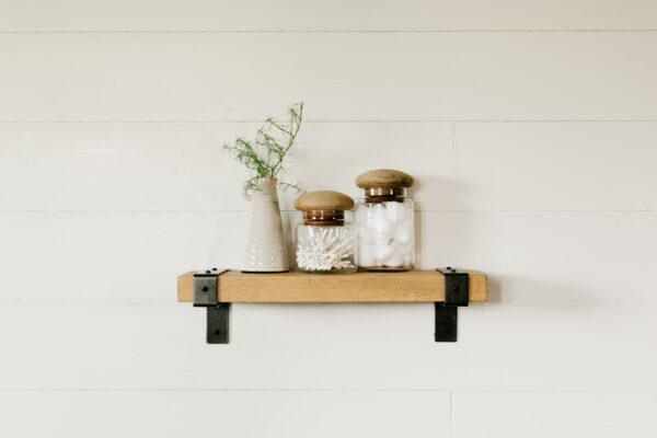 wooden industrial shelf hanging on a wall