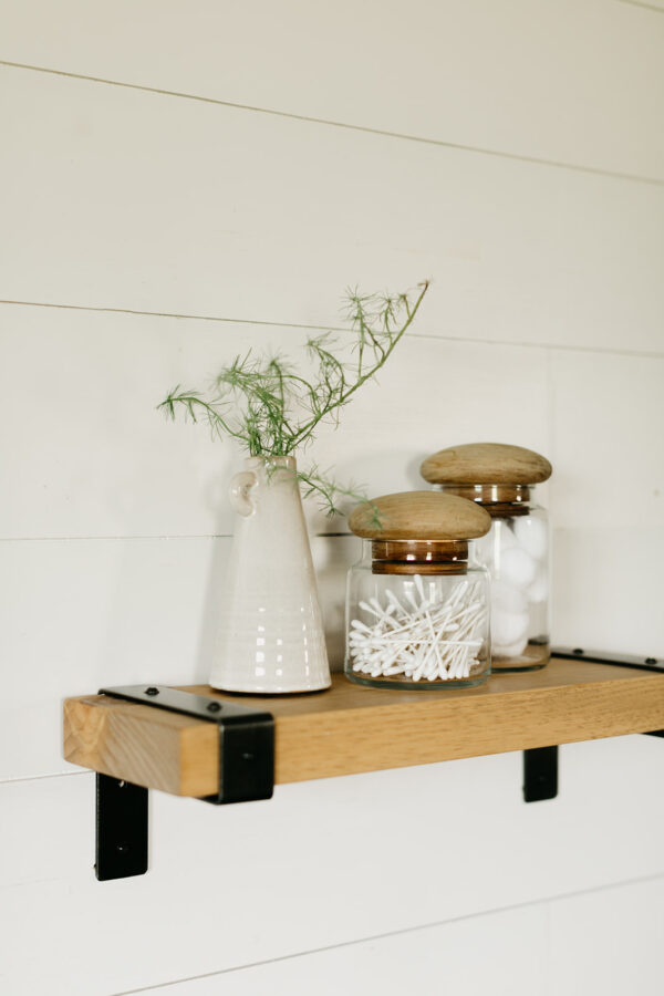 wooden industrial shelf hanging on a wall