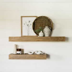 medium and large floating wooden shelves hanging on a wall holding small houseware items