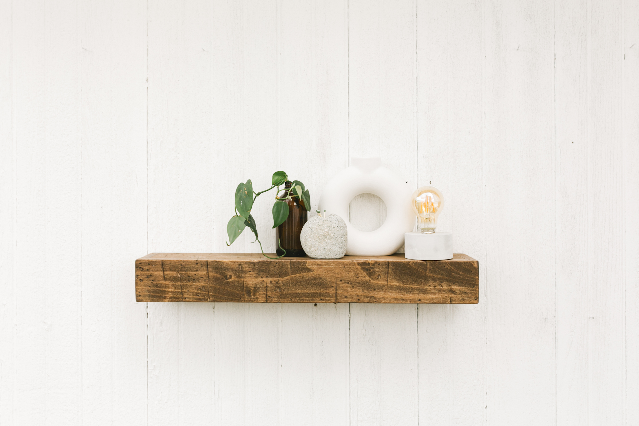 mini floating shelf holding small houseware items