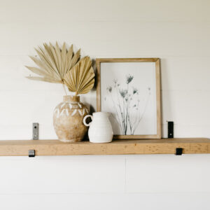 modern bracket shelf hanging on the wall holding small houseware items