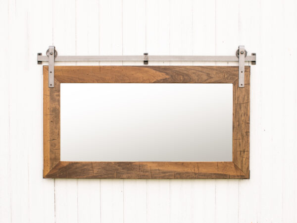 wooden framed mirror and metal wall track hung horizontally