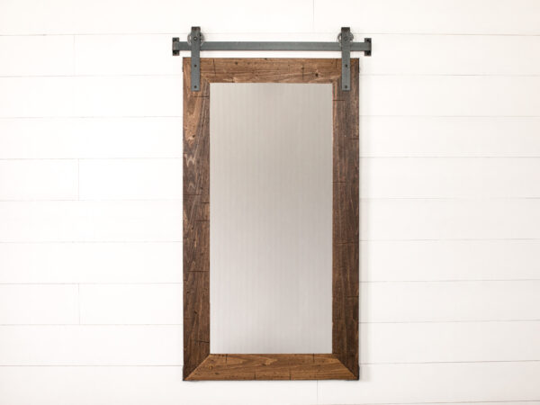 wooden framed mirror and metal wall track hung vertically